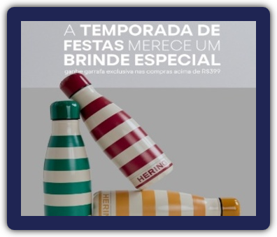 Imagem que promove a "Promoção Compre e Ganhe Natal Hering 2024". A imagem exibe a garrafa térmica exclusiva que será dada como brinde para clientes que realizarem compras acima de R$ 399,00 em produtos da marca Hering.