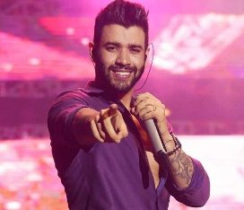 Imagem promocional com foto do cantor Gusttavo Lima em show ao vivo, acompanhada da lista de cidades e datas dos shows de junho de 2025.