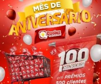 Imagem promocional do aniversário do Supermercado QueLuz em Santa Catarina. A imagem destaca a campanha especial de prêmios, com destaque para o valor de 100 mil reais em vale-compras. Mostra clientes participando e celebrando as ofertas, com ícones de carrinho de compras, cédulas de dinheiro e o logotipo do supermercado.