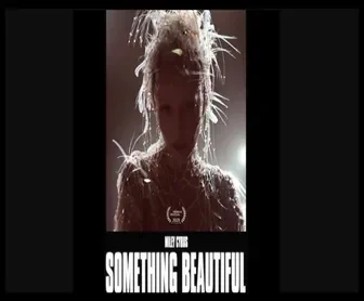 Capa promocional do álbum visual "Something Beautiful" de Miley Cyrus com estilo artístico e iluminação dramática.
